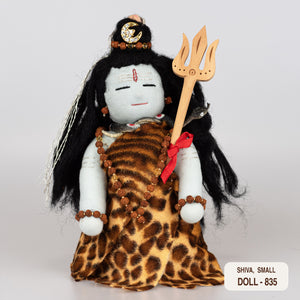A handcrafted doll of the Hindu god Shiva, dressed in a tiger skin garment, holding a trident, with a cobra around the neck and matted hair.